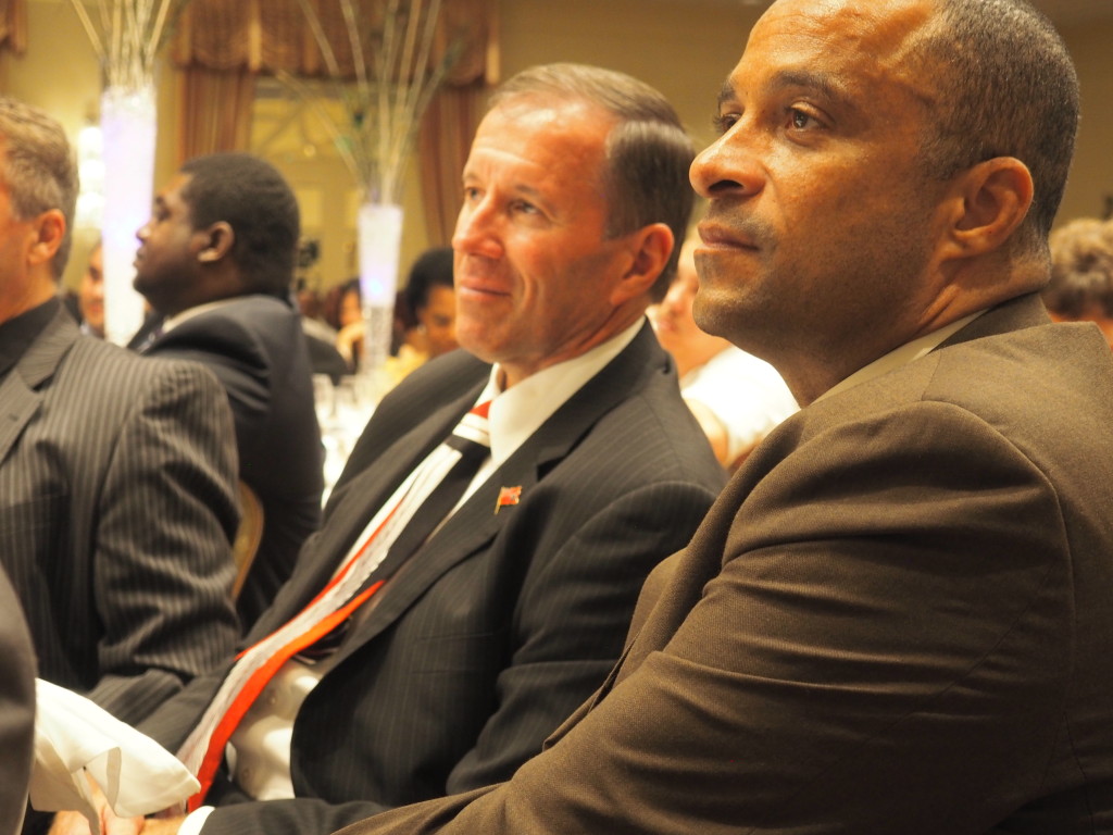 Premier Michael Dunkley (l) and Community Affairs Minister Wayne Scott listen to Ewart Brown's keynote address